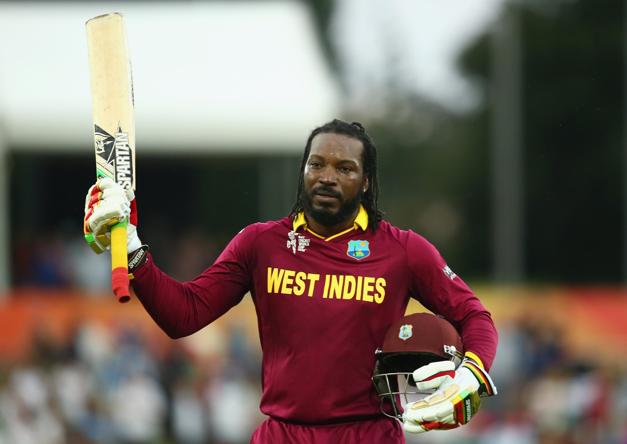 greatest t20 batsmen of all time- chris gayle in west indies jersey holding the bat